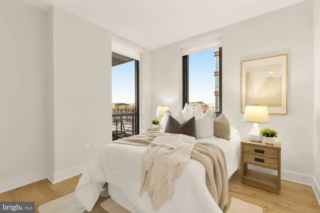 a bedroom with a bed and a painting on the wall