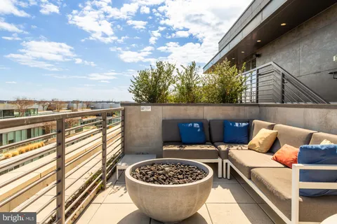 a view of a roof deck with furniture