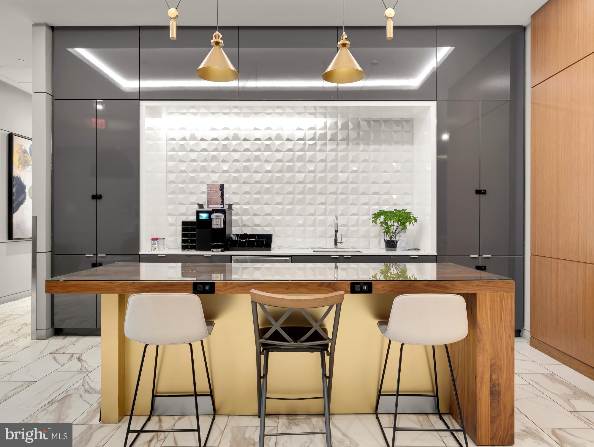 1211 Van Street Southeast, Unit 718 Washington, DC 20003 - Photo 37 of 43 a kitchen with stainless steel appliances granite countertop a sink and a refrigerator