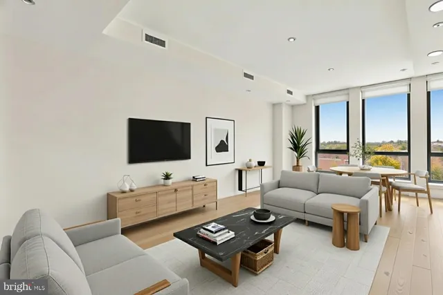 a living room with furniture a flat screen tv and a large window