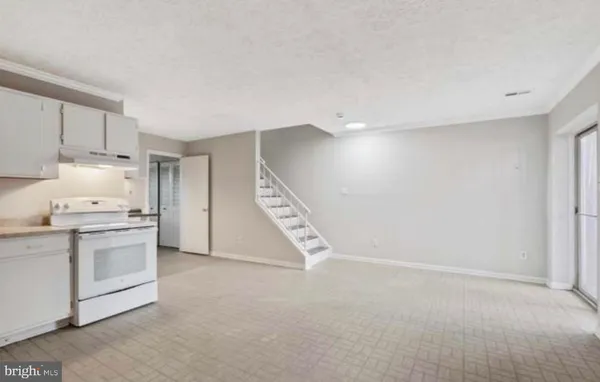 a kitchen with stainless steel appliances granite countertop a stove a refrigerator and a refrigerator