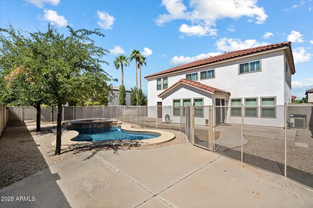an empty room with a window and a ceiling fan