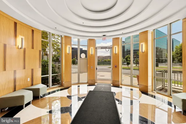 a lobby with furniture and large windows