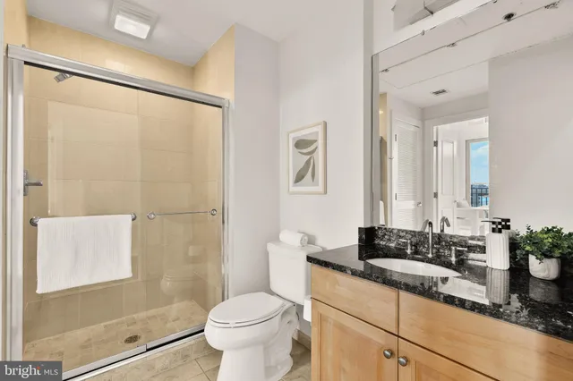 a view of a garage with a lot of stuff and a car parked in garage