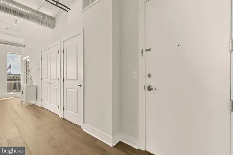 a view of a hallway with wooden floor