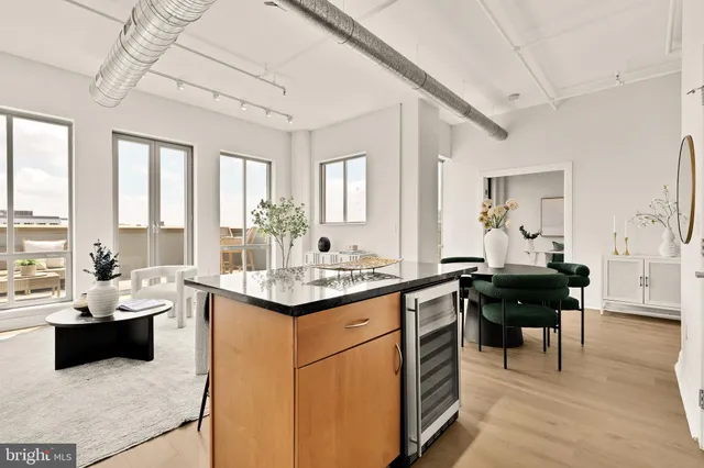 a kitchen with a sink and living room