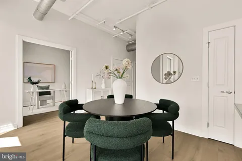 a dining room with furniture and wooden floor