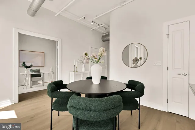 a dining room with furniture and wooden floor