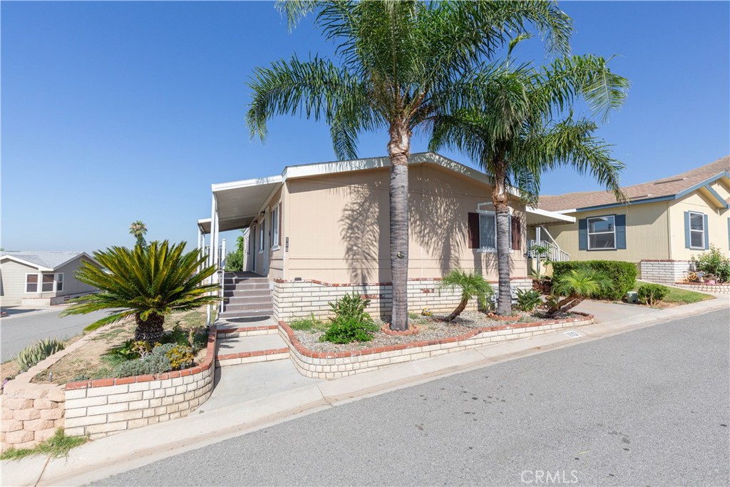 a front view of a house with a garden and potted plants