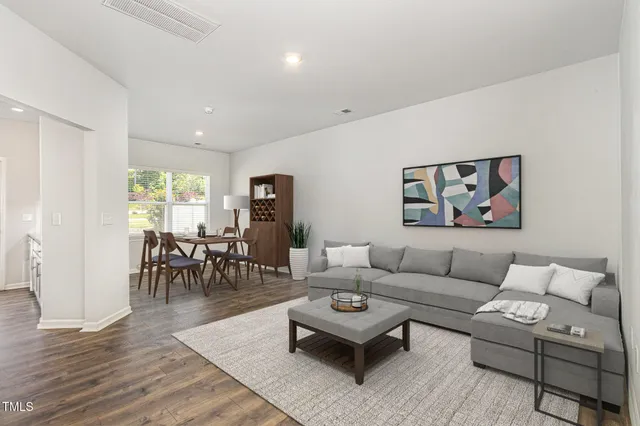 a living room with furniture potted plant and a table
