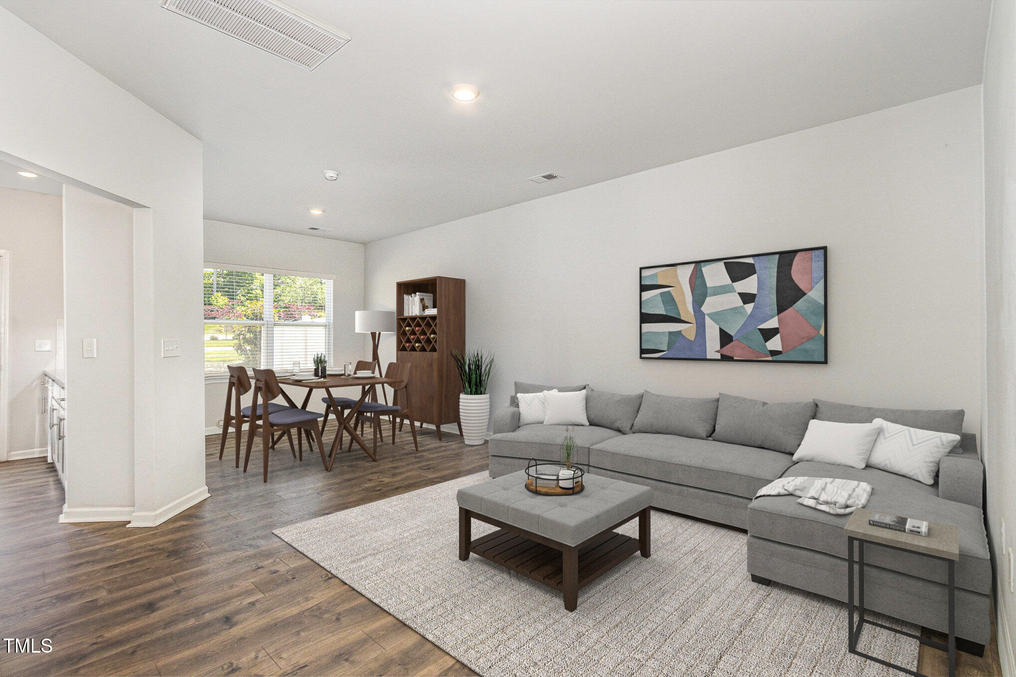 a living room with furniture potted plant and a table