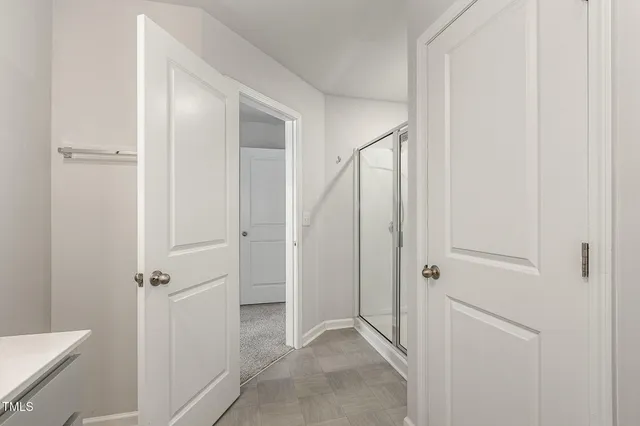 a bathroom with a glass shower door