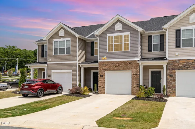 a view of a house with a backyard and a table and chair