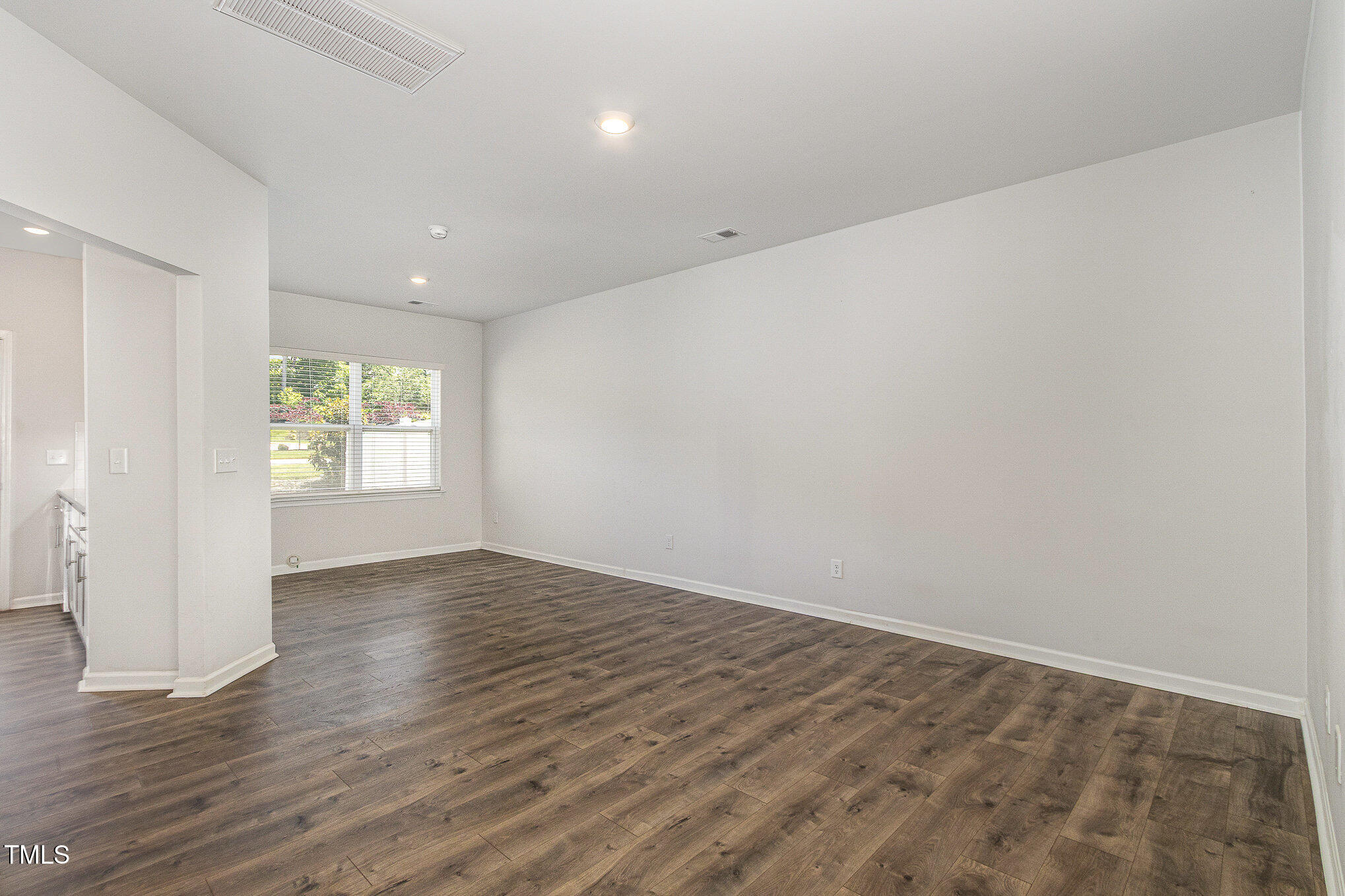 1230 Adrian Court Mebane, NC 27302 - Photo 3 of 31 an empty room with wooden floor and windows