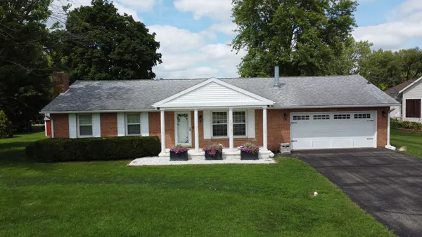 a front view of a house with a garden and porch