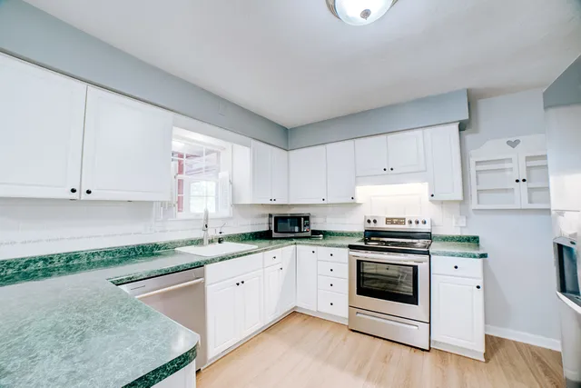 a kitchen with stainless steel appliances a refrigerator and a stove