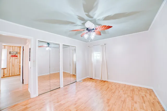 a view of a hallway with a chandelier fan