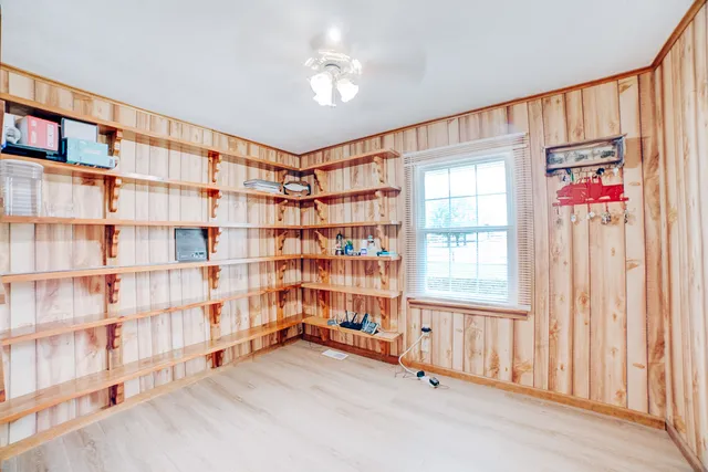 a hallway with stairs and wooden floor