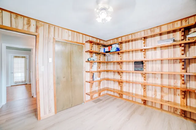 a living room with stairs and a wooden floor