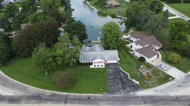 an aerial view of a house with a garden and trees
