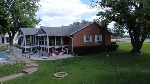 a view of a house with a yard porch and sitting area
