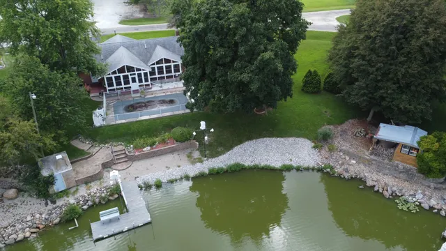 an aerial view of a house with outdoor space swimming pool and lake view