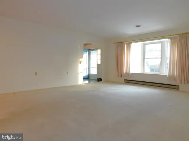 an empty room with a empty space and windows