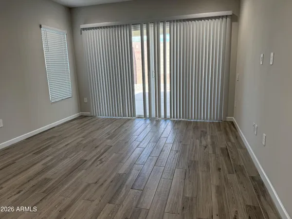 a kitchen with wooden floors white cabinets and stainless steel appliances