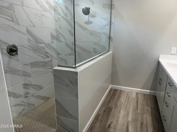 a bathroom with a granite countertop toilet and a sink