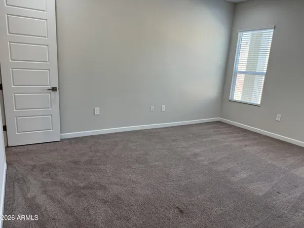 an empty room with view of bathroom