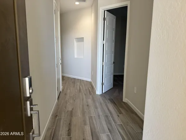 a view of hallway with wooden floor