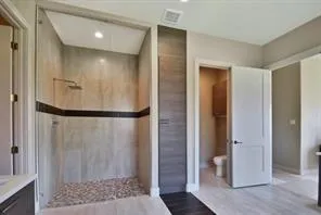 a bathroom with a shower and a sink