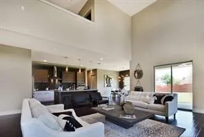 a living room with furniture and view of kitchen