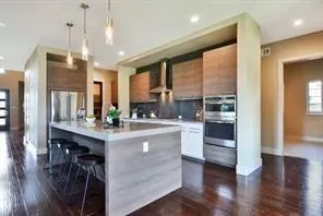 a kitchen with kitchen island granite countertop a table chairs sink and cabinets