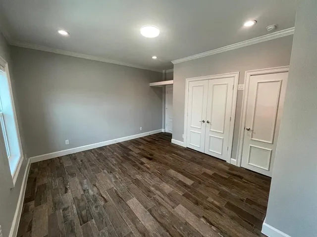 wooden floor in an empty room with a window