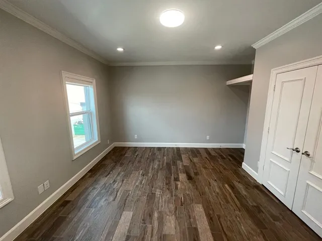 a view of staircase with wooden floor and small window