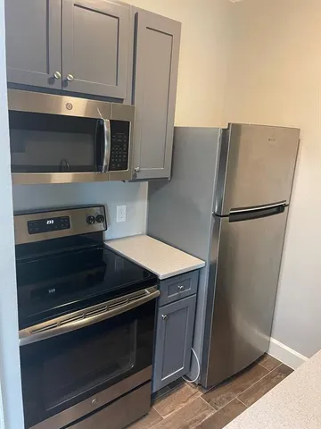 a kitchen with appliances and cabinets