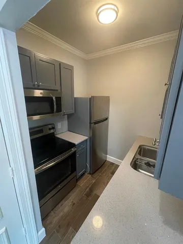 a kitchen with a refrigerator stove and microwave