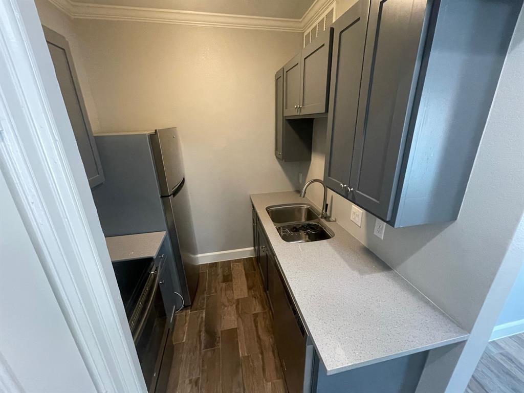 3101 Commerce Street, Unit 203 Dallas, TX 75226 - Photo 9 of 21 a kitchen with a sink a refrigerator and washer