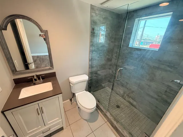 a bathroom with a toilet a sink and shower