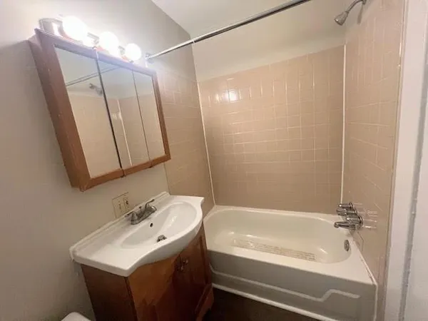 a bathroom with a sink a mirror and a bathtub