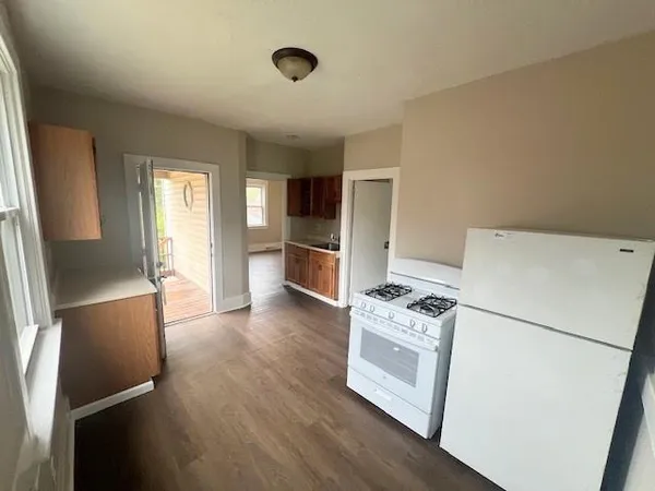 a kitchen with stainless steel appliances a refrigerator and a stove top oven