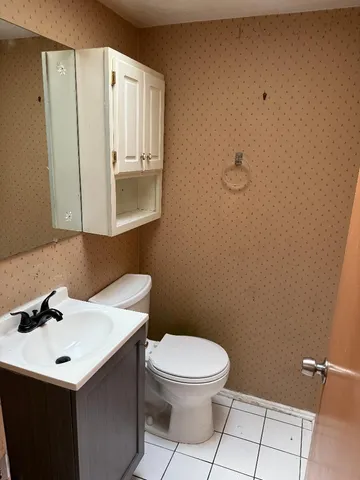 a bathroom with a sink a toilet and mirror