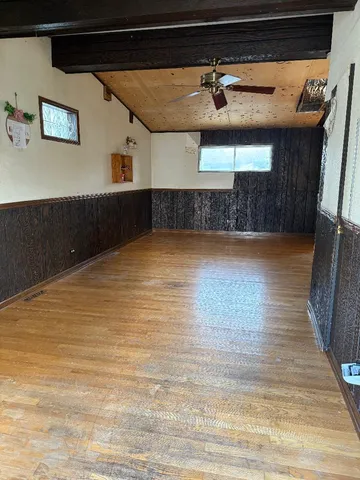 a view of a room with wooden floor