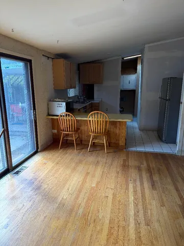 a living room with a couch wooden floor and a fireplace