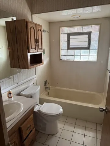 a bathroom with a sink a toilet and bathtub