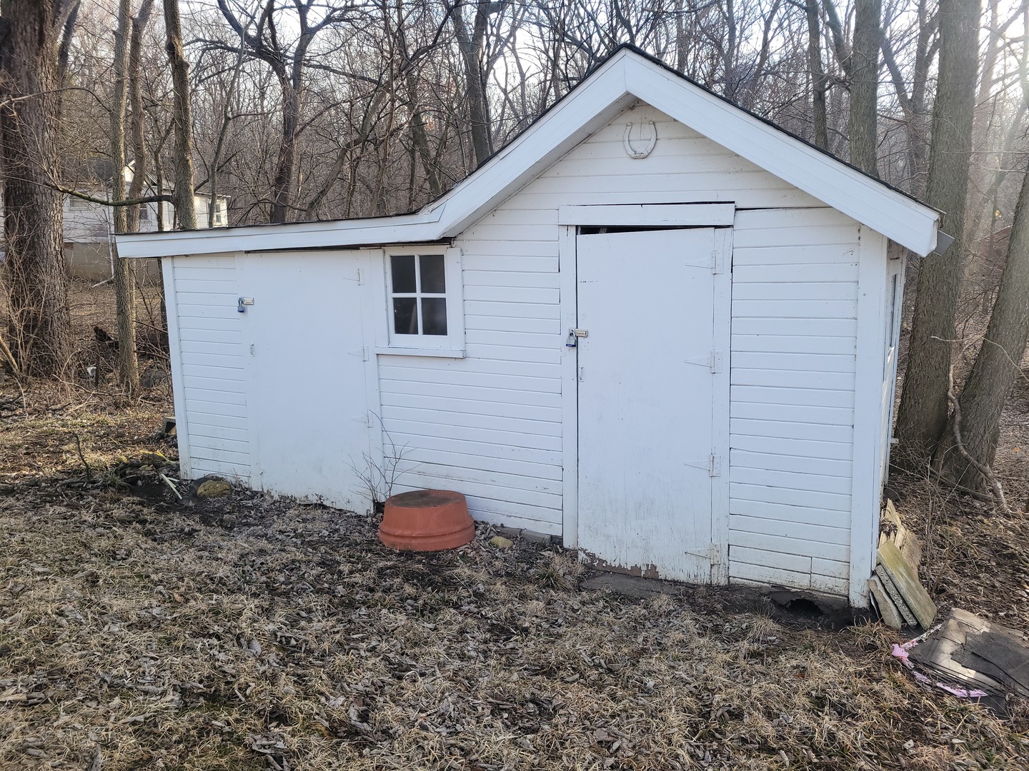 1977 North 3103rd Road, Unit 11 Ottawa, IL 61350 - Photo 3 of 24 a view of a small white house with a small yard