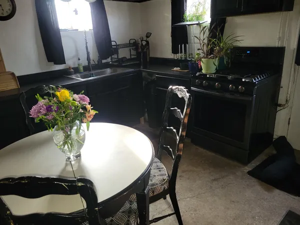 a dining room with furniture and window