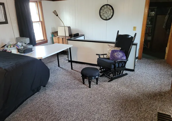 a view of workspace with wooden floor and window