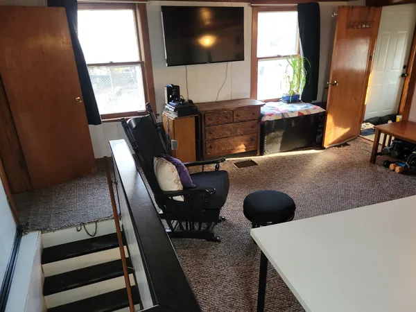 a view of a workspace with furniture and window